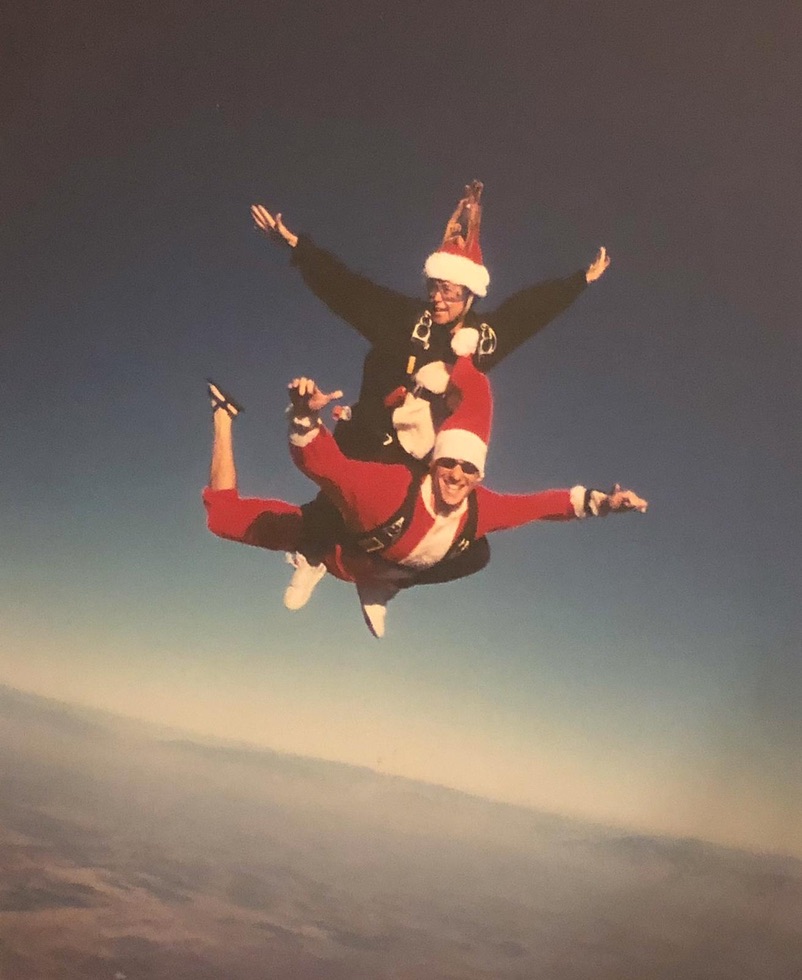 Bill and his wife Micki skydiving together in festive Santa and reindeer attire